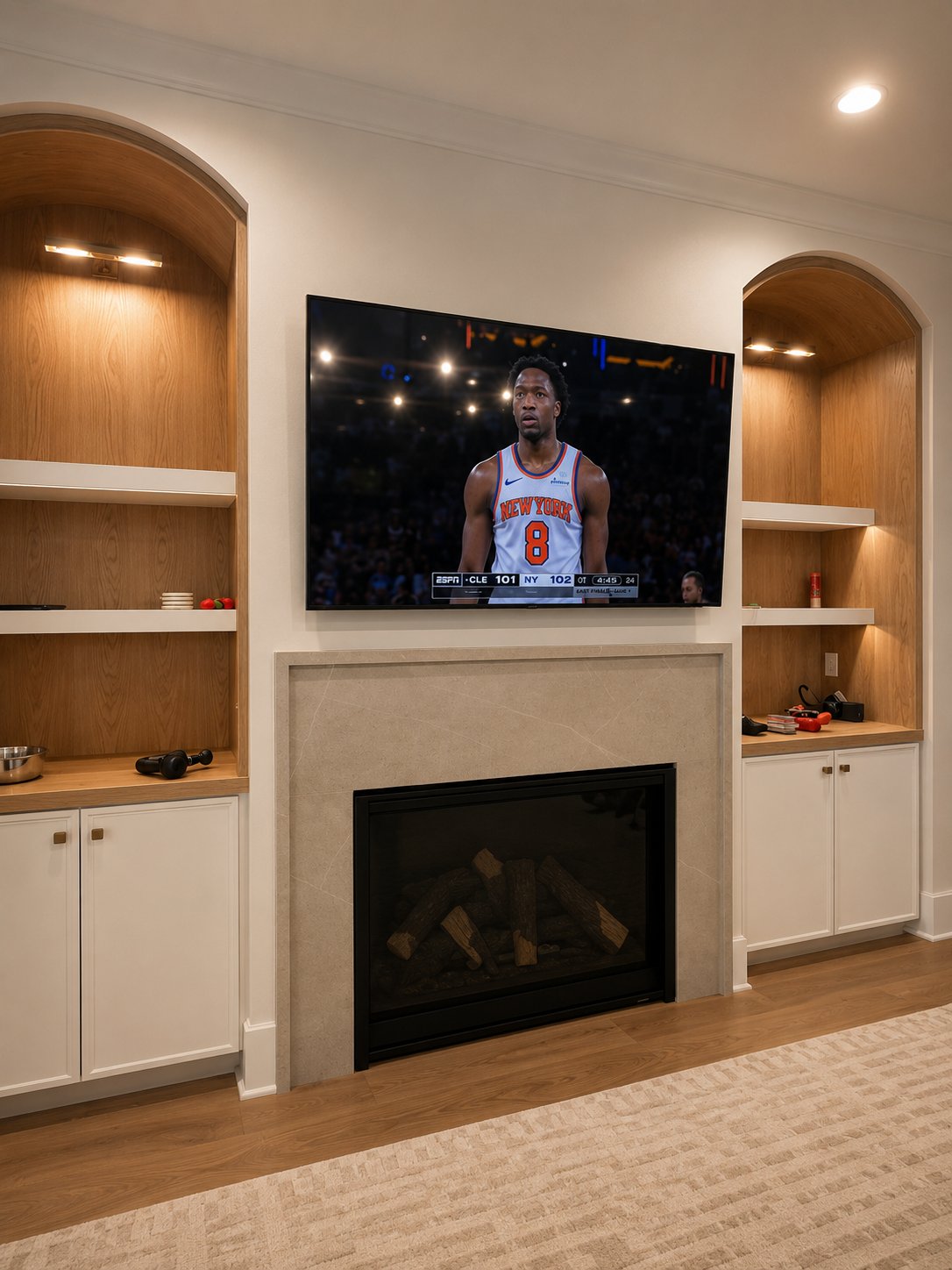 Modern TV on built-in shelving with warm accent lighting Cary NC
