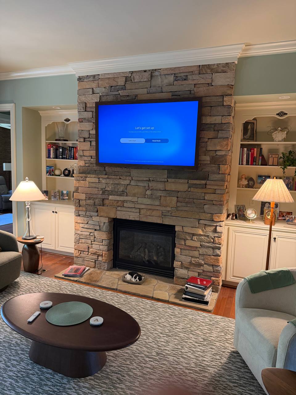 Samsung The Frame TV above manufactured stone fireplace in Apex, NC
