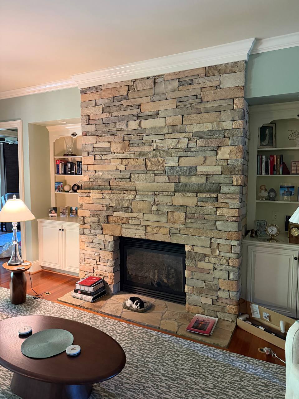 Uneven manufactured stone fireplace before Samsung The Frame TV installation in Apex, NC